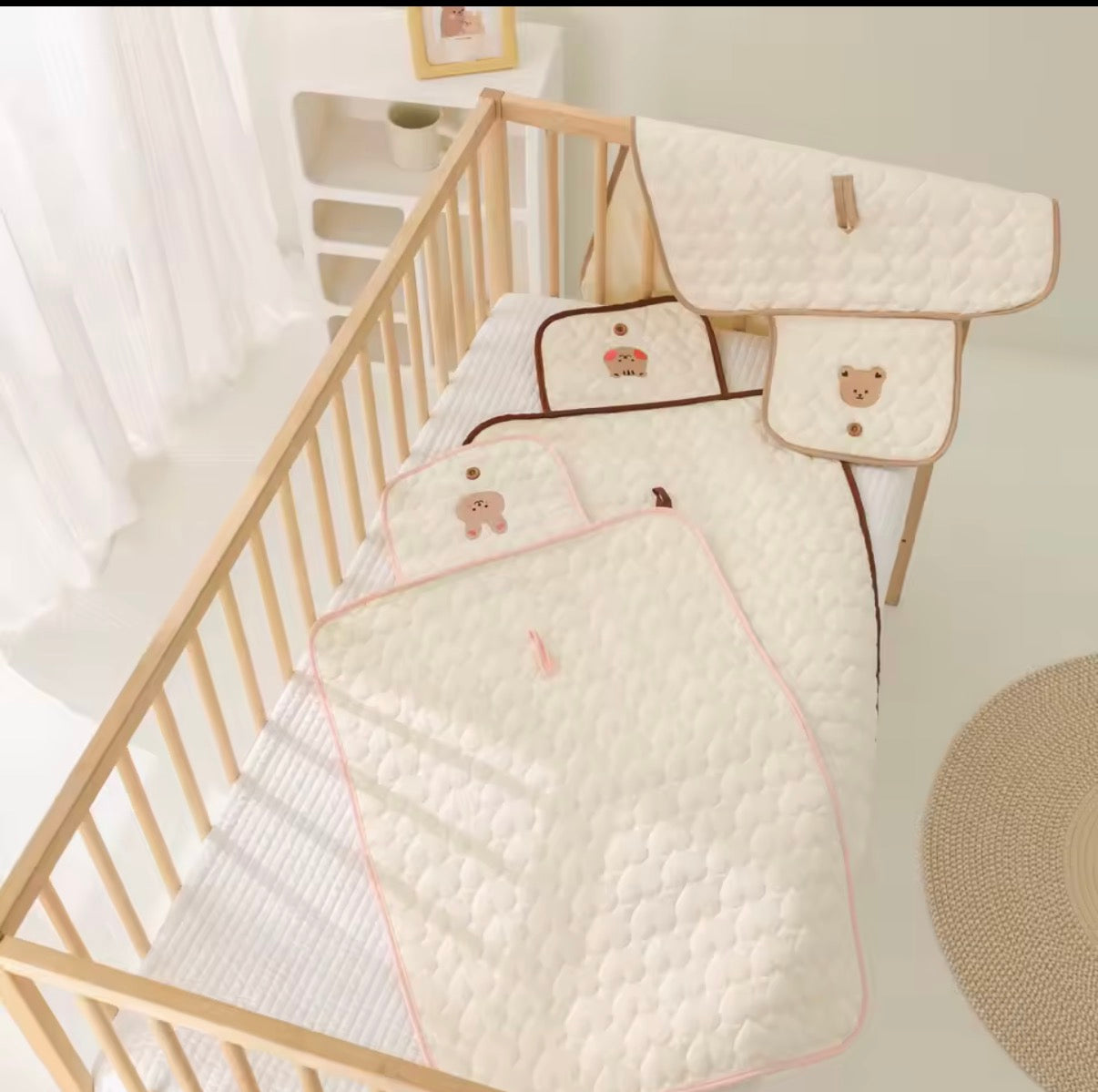 Hand-sewn changing mats in a crib